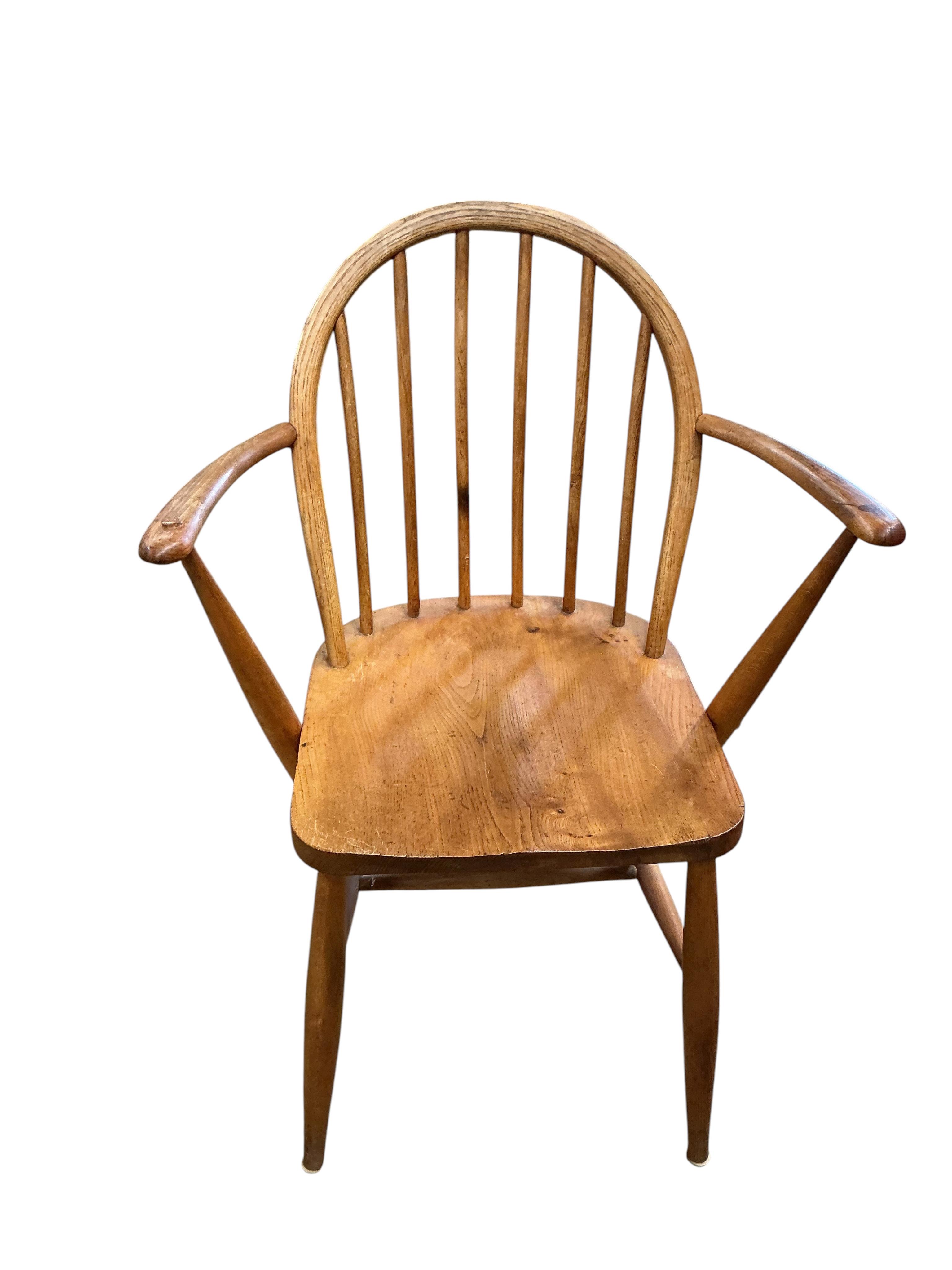 A pair of Ercol elm and beech comb back Windsor elbow chairs, width 60cm, depth 40cm, height 86cm